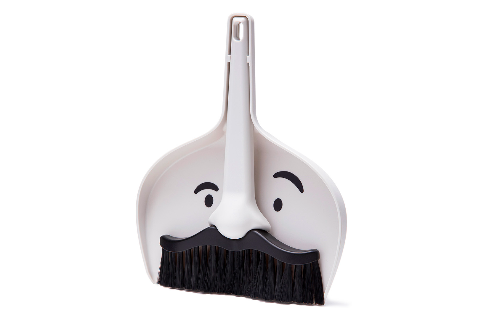 A dustpan than has a moustache for a bush on a white background.