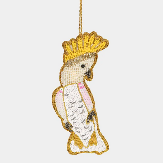 Decorative ornament shaped like a bird with a yellow beak and crown on a white background