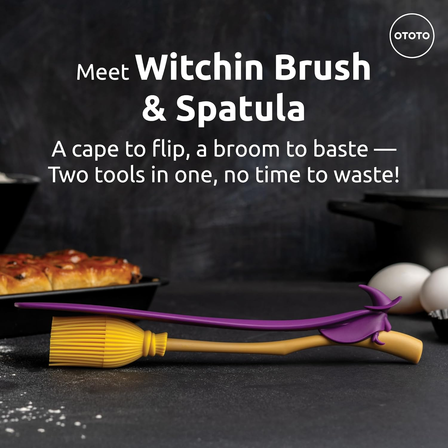 A lifestyle picture of the witchin pastry brush and spatula on a dark kitchen background.