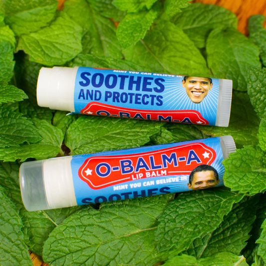 A background of peppermint and two ials of O-Balma lip balms