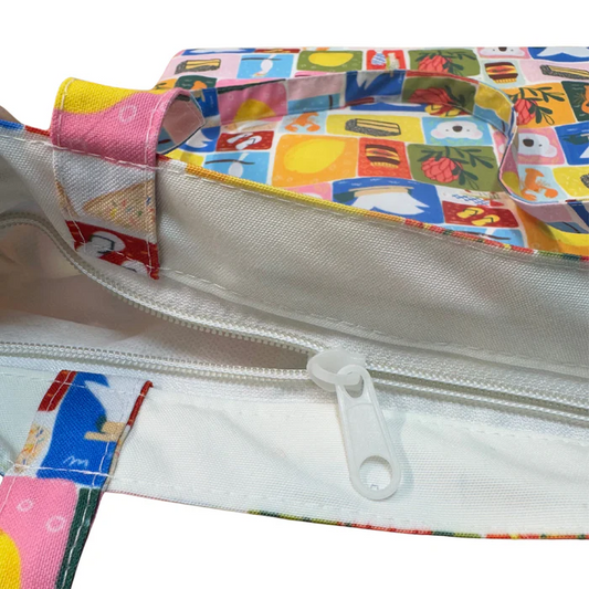 Colorful fabric pouch with a white zipper on a white background