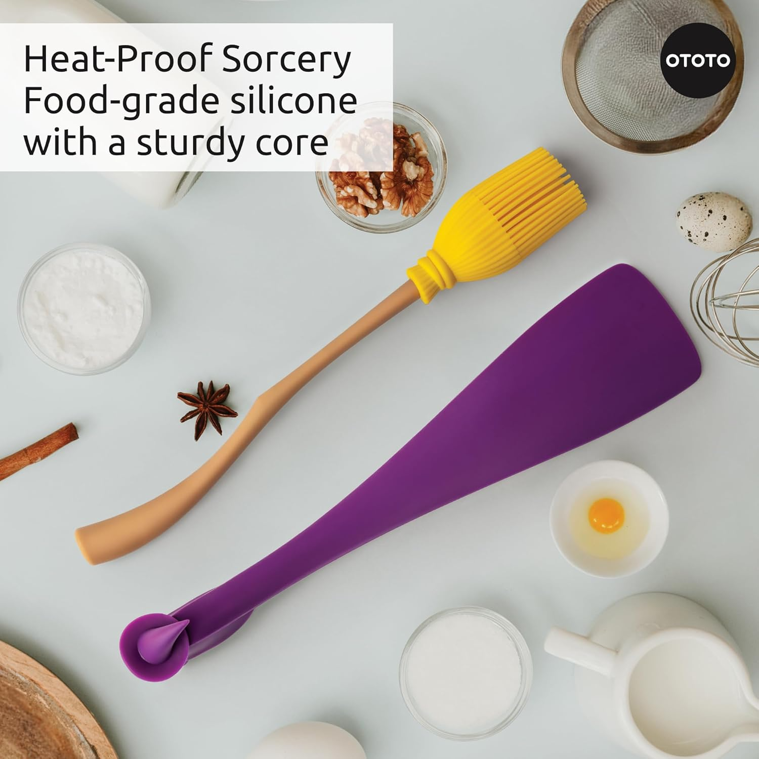 A counter picture featuring cooking ingredients and an aerial view of pastry brush and spatula.