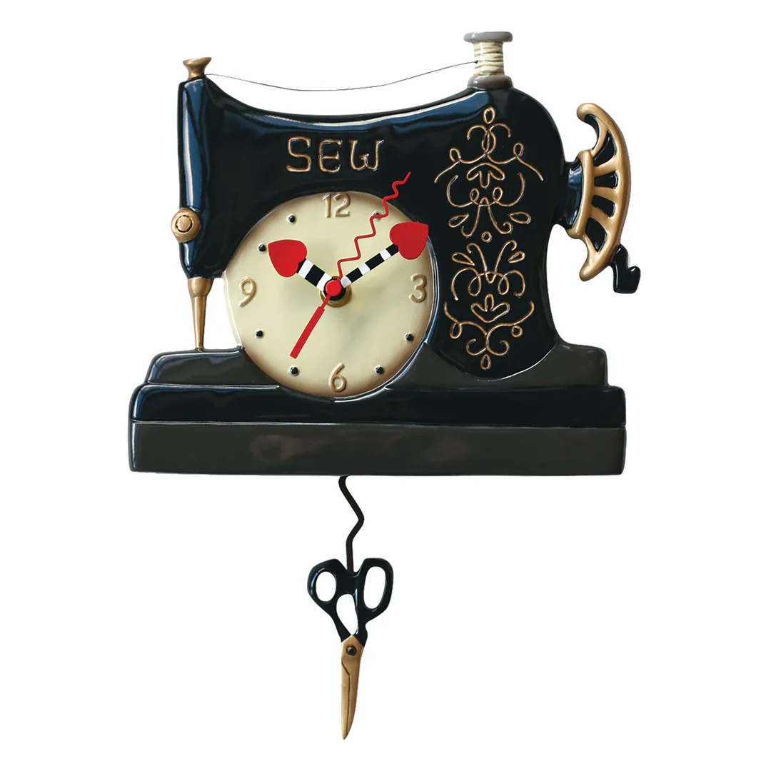 Decorative clock designed like a sewing machine with pendulum scissors on a white background