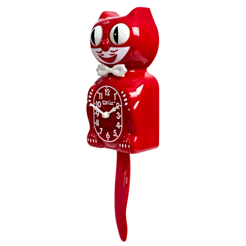 Red cat-shaped clock with a white bow tie on a white background
