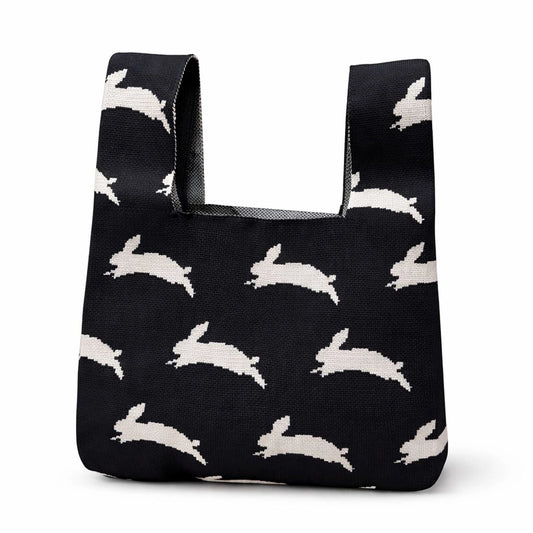 A black bag with leaping white rabbits on a white background.