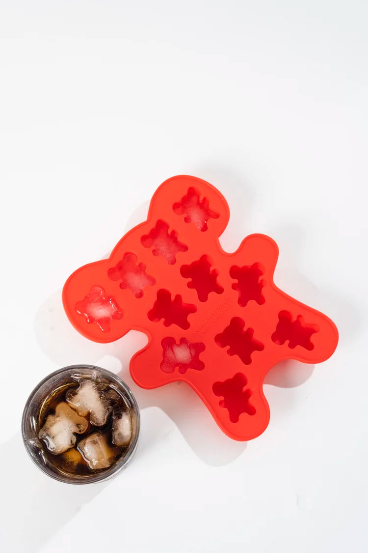 Red silicone ice cube tray with star-shaped molds on a white background