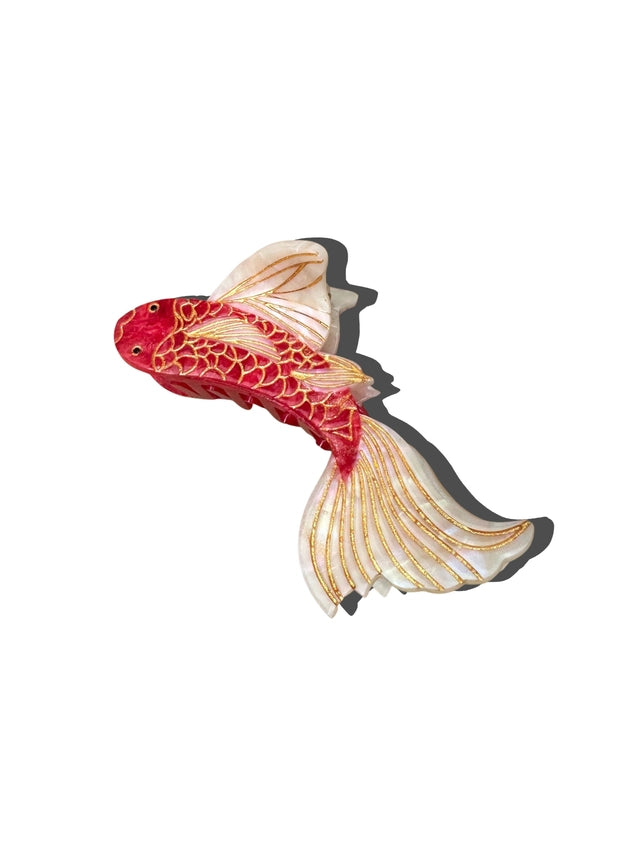 Decorative Koi fish-shaped hair claw with red and gold patterns on a white background