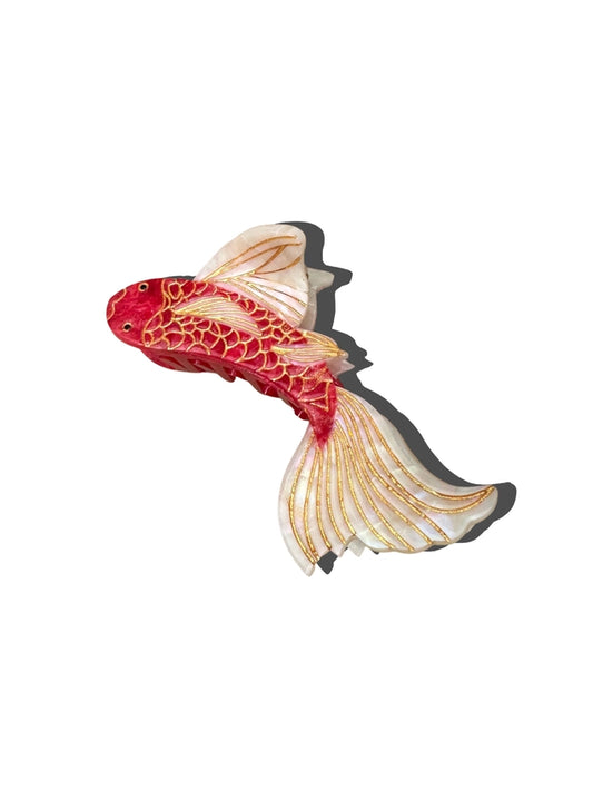 Decorative Koi fish-shaped hair claw with red and gold patterns on a white background