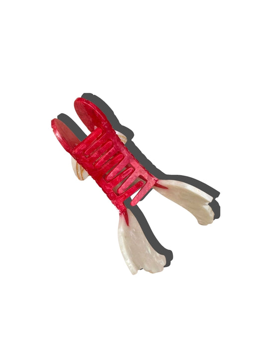 Red and black side view of hair claw with a white background