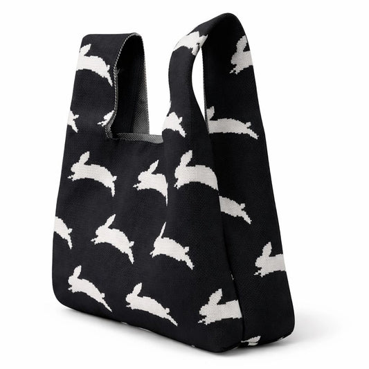 A black bag featuring white rabbits on a white background.