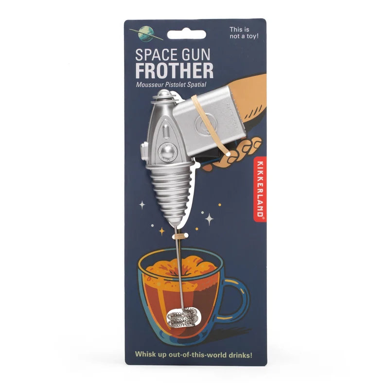 A space gun shaped milk frother on a navy backing card on a white background.