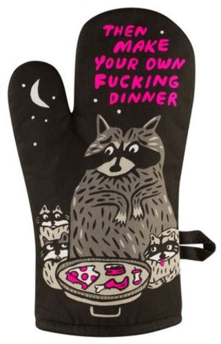 An oven glove with a black background featuring a cartoon raccoon and text that reads 'Then make your own f***ing dinner' with a pink bowl of food in the center.