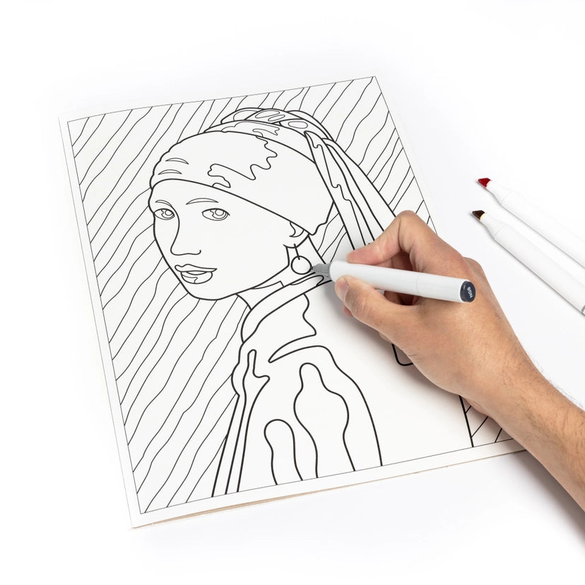 A hand holds a white marker with a black cap, coloring a black-and-white line art portrait of a woman on a white sheet of paper. Two additional markers are visible on the right side against a clean white background.
