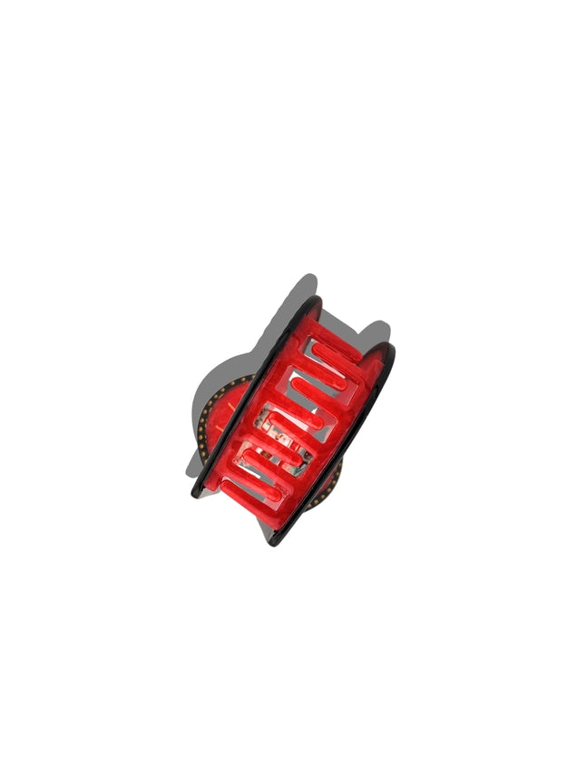 Side view Red and black hair clip on a white background