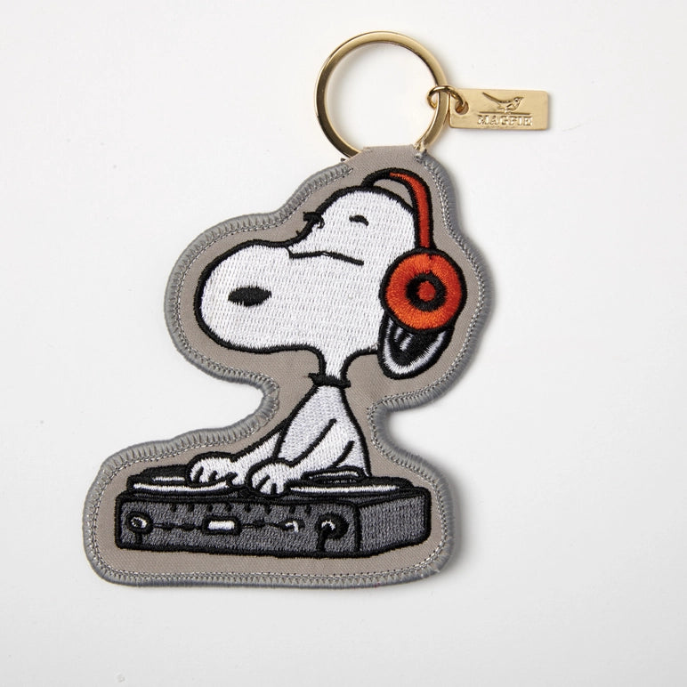 Keychain with Snoopy DJ design on a light gray background