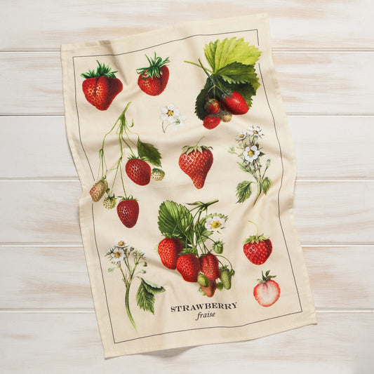 Tea towel with strawberry design on a wooden surface