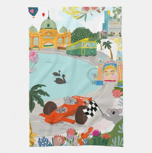 Colorful tea towel with a cartoon race car, koala, and  Melbourne cityscape design.