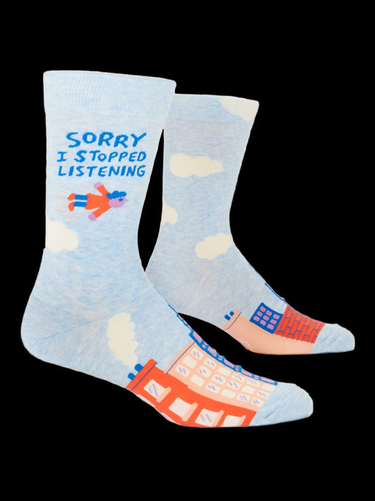 Light blue socks with colorful designs and text on a black background