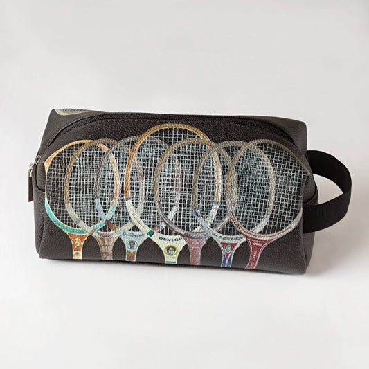 Black toiletry bag with colorful tennis racket designs on a white background