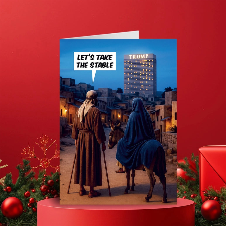 A nativity scene greeting card on a red podium and a red festive background.