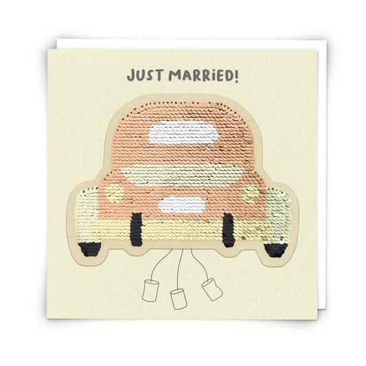 Card with a sequin-covered car illustration and 'Just Married!' text on a beige background
