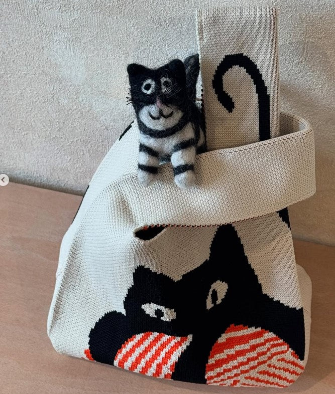 Cat toy with a black and white cat design on a textured surface